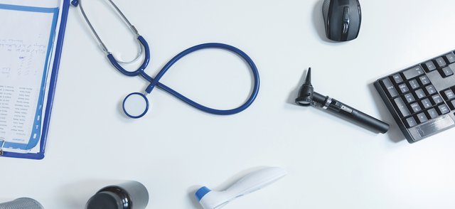 Top view of medical examination tools standing on table